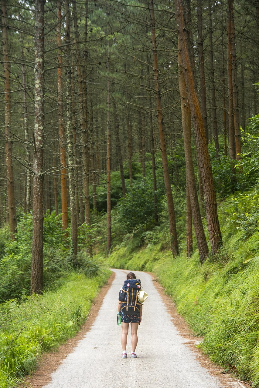 A woman walking a path through the forest